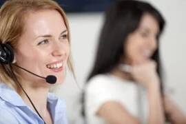 Two colleagues working in a busy call centre office